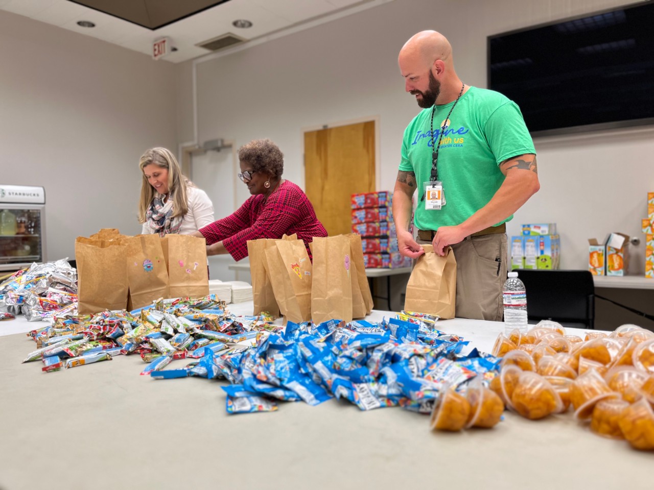 Southern Nuclear team members pack lunch bags with snacks and meals, supporting local outreach and building a strong nuclear community.
