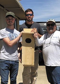 Eagle Scout candidate Will Smith presents a wood duck box to Farley Environmental Specialist Seth Harrison (center) and Facilities Foreman Corby Dolar (right). Seven new next boxes were installed at Plant Farley on May 15, 2021.